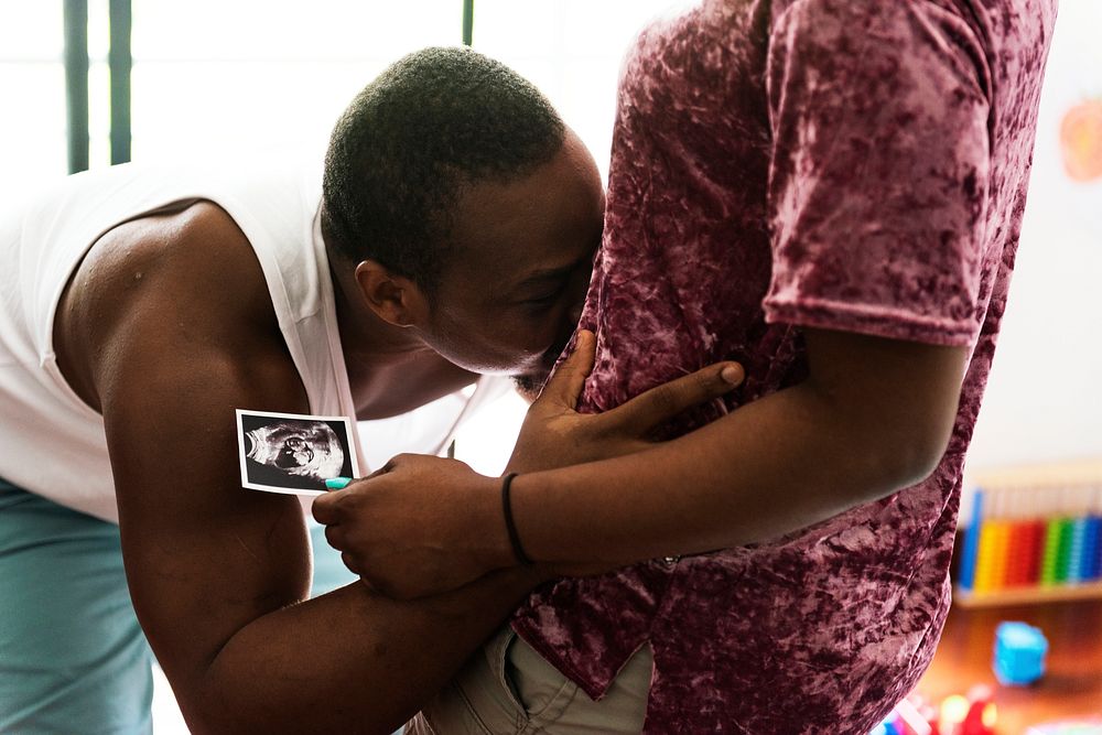 Black couple with baby ultrasound scan photo