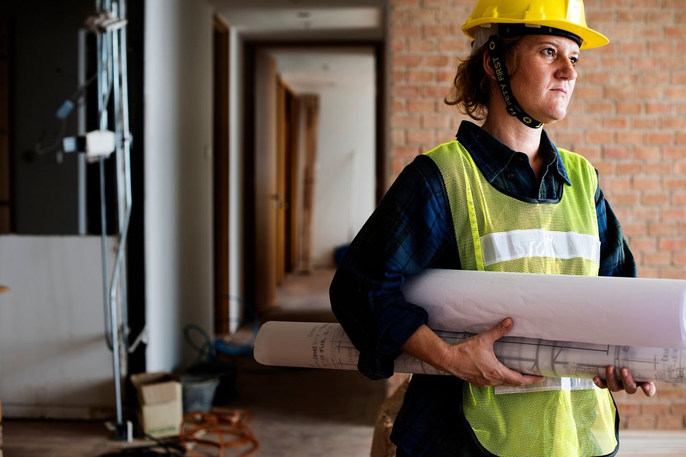 Construction woman holding blueprint