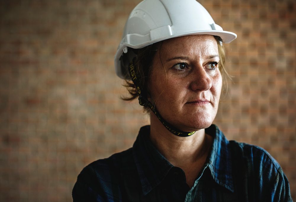 Woman constructor wearing hard helmet