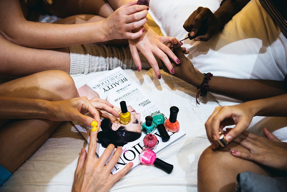 A group of diverse women painting their nails