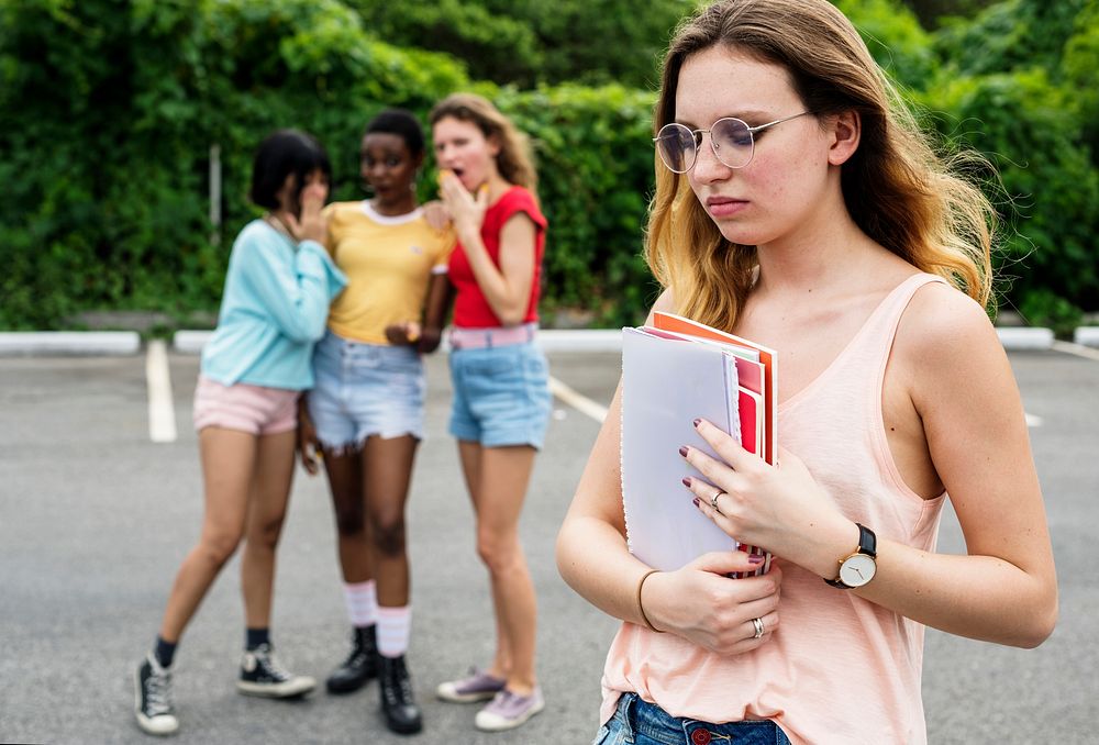 Caucasian woman being bullying from other girls