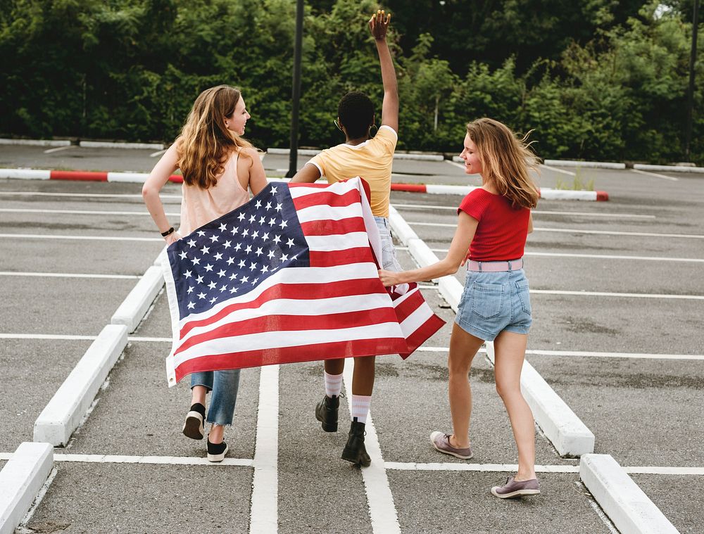 Rear view of diverse women group with American nation flag