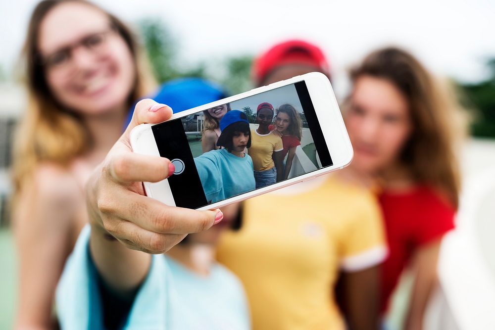 Group of diverse women taking selfie together