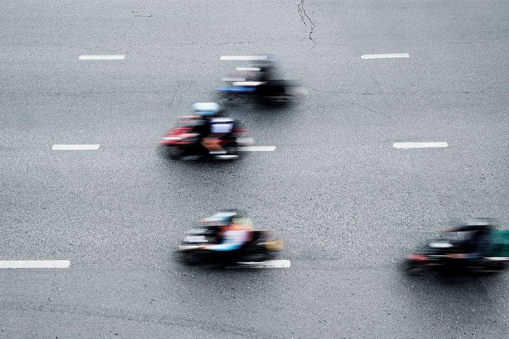 Aerial view of blurred motorbikes on the street in downtown