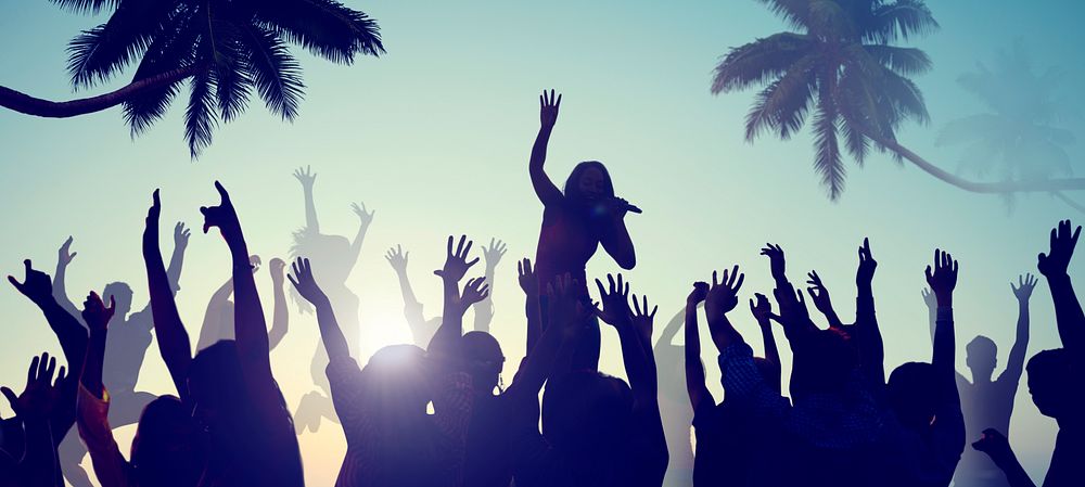 Silhouettes of Young People on a Beach Concert