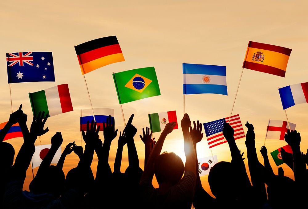 Silhouettes of People Holding Flags From Various Countries