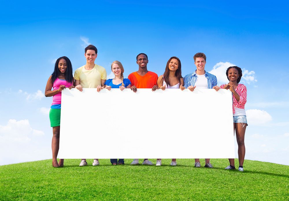 Multi-Ethnic Teenagers Outdoors Holding Empty Billboard for Copy Space