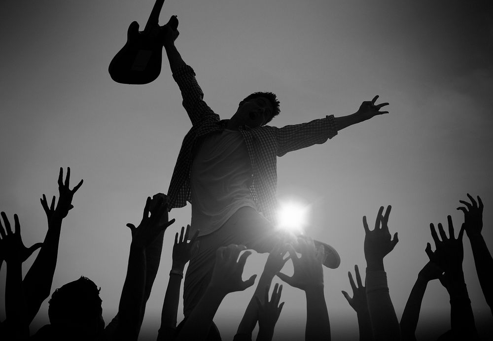 Silhouette of a Young Man Performing in Front of the Crowd