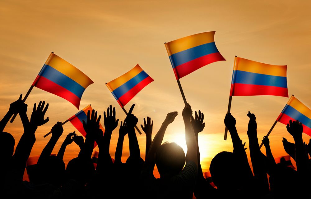 Silhouettes of People Holding Flag of Colombia