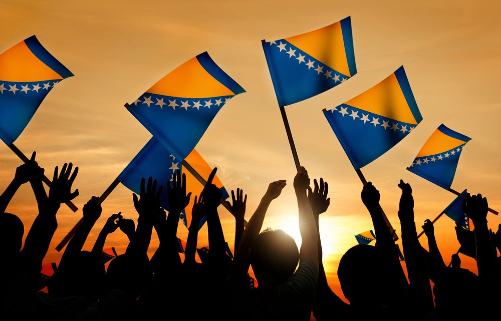 Silhouettes of People Holding Flag of Bosnia and Hercegovina