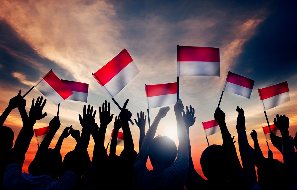 Silhouettes of People Holding the Flag of Indonesia