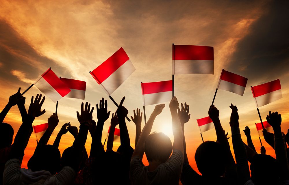 Silhouettes of People Holding the Flag of Indonesia