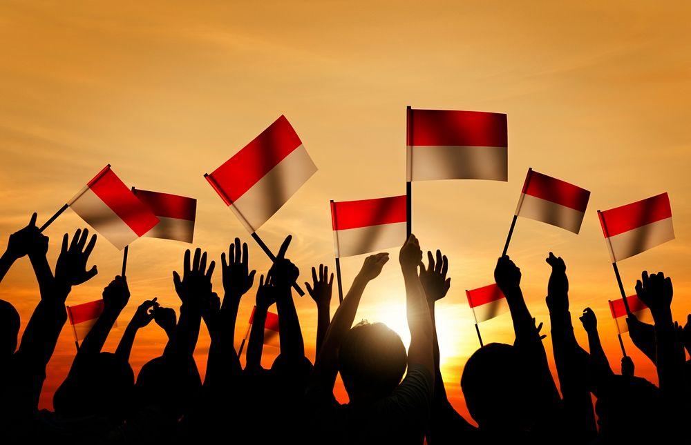 Silhouettes of People Holding the Flag of Indonesia