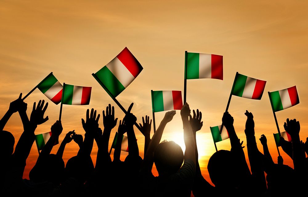 Group of People Waving Italian Flags in Back Lit