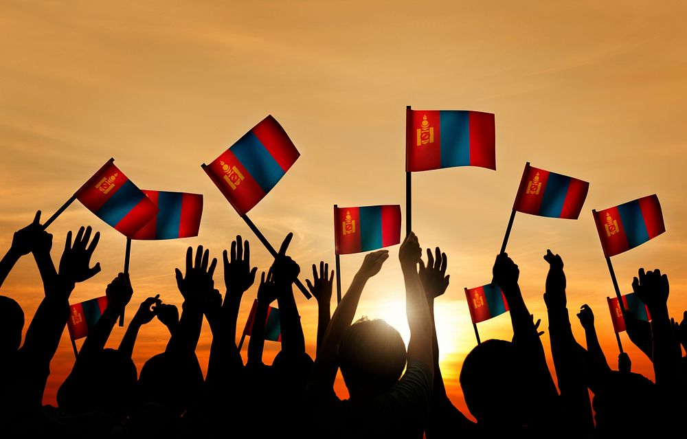 Group of People Waving Mongolian Flags in Back Lit