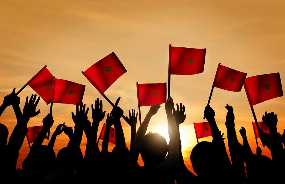 Silhouettes of People Holding the Flag of Morocco