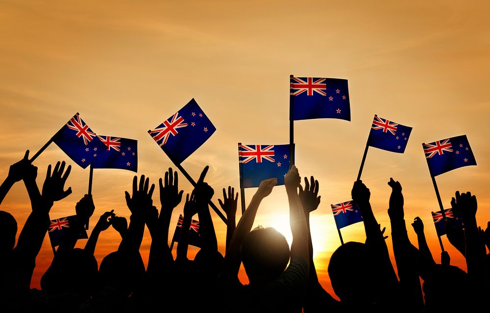 Silhouettes of People Holding Flag of New Zealand