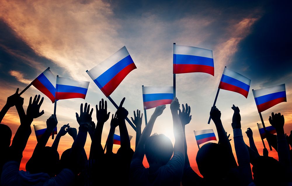 Group of People Waving Russian Flags in Back Lit