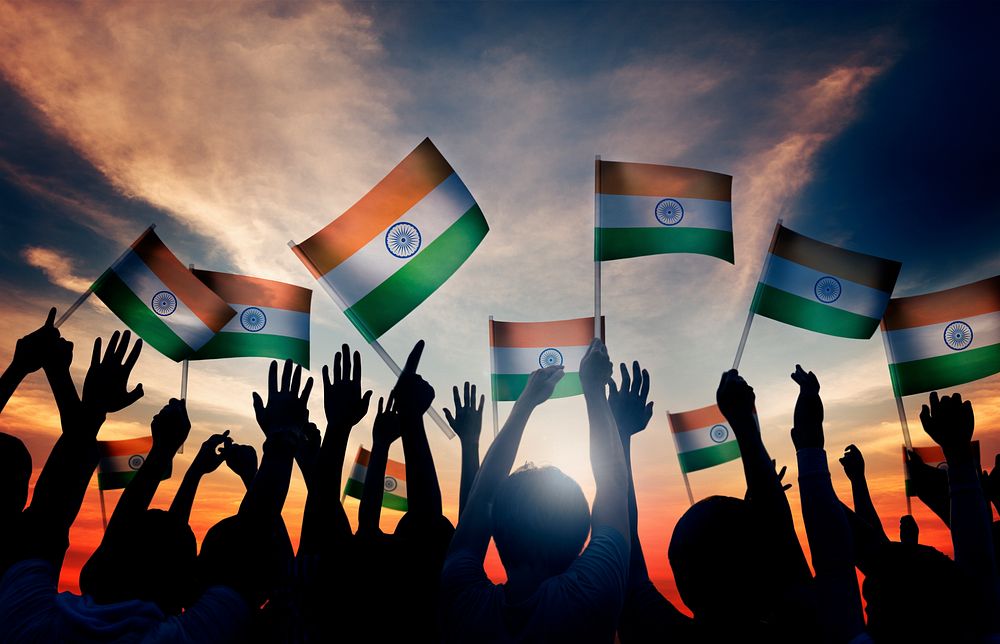 Group of People Waving Indian Flags in Back Lit