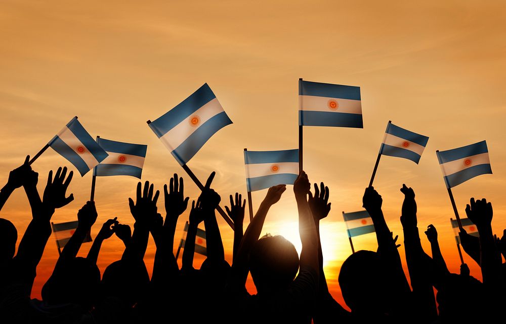 Silhouettes of People Holding Flag of Argentina