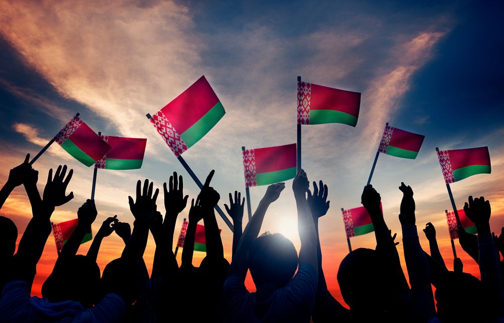 Silhouettes of People Holding Flag of Belarus