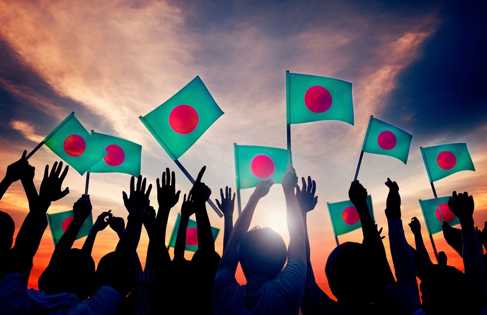 Silhouettes of People Holding Flag of Bangladesh