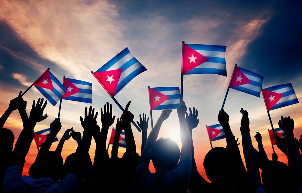 Silhouettes of People Holding Flag of Cuba