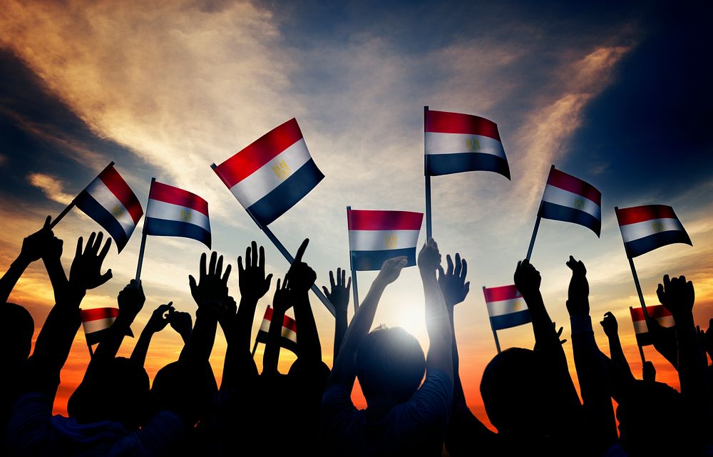 Silhouettes of People Holding the Flag of India