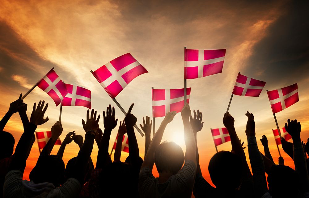 Silhouettes of People Holding the Flag of Denmark