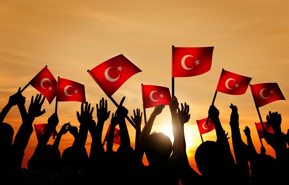 Silhouettes of People Holding the Flag of Turkey