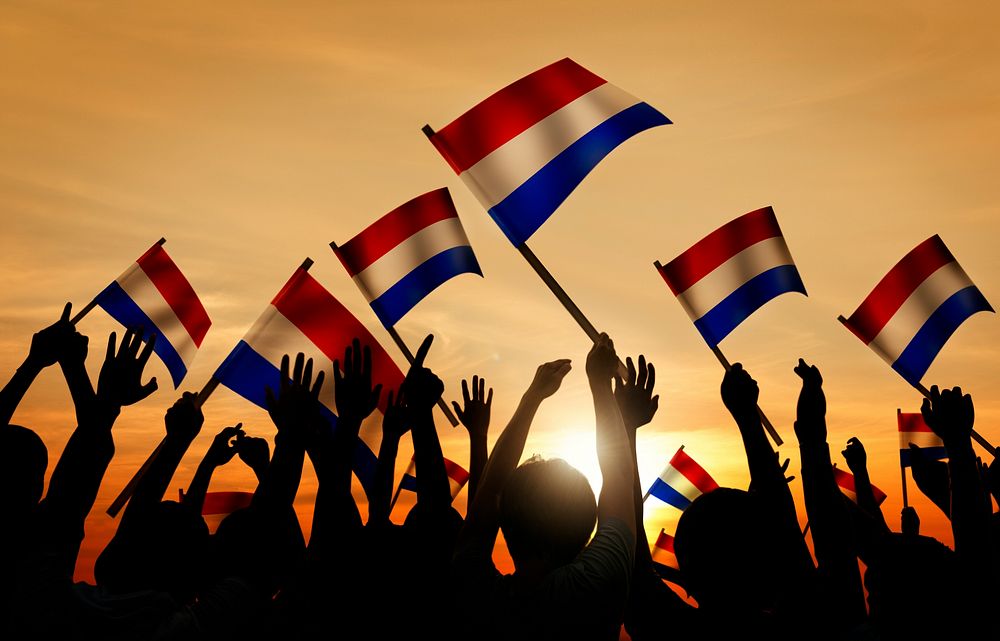 Silhouettes of People Holding Flag of Netherlands