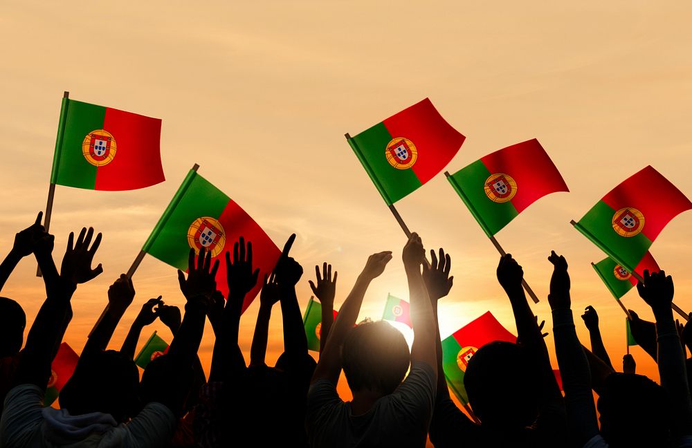 Silhouettes of Peopel Holding Portuguese Flags