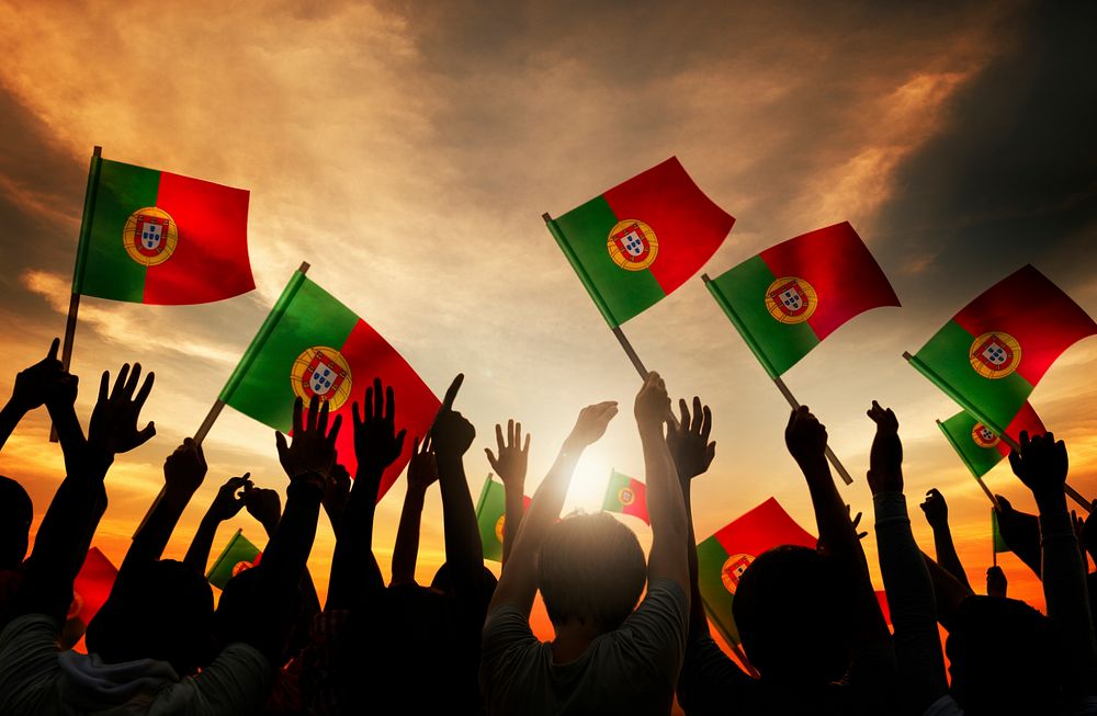 Silhouettes of People Holding Flag of Portugal