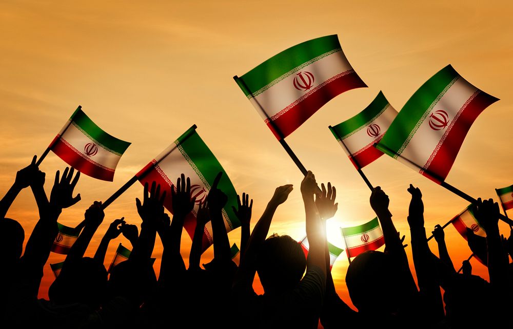 Silhouettes of People Holding Flag of Iran