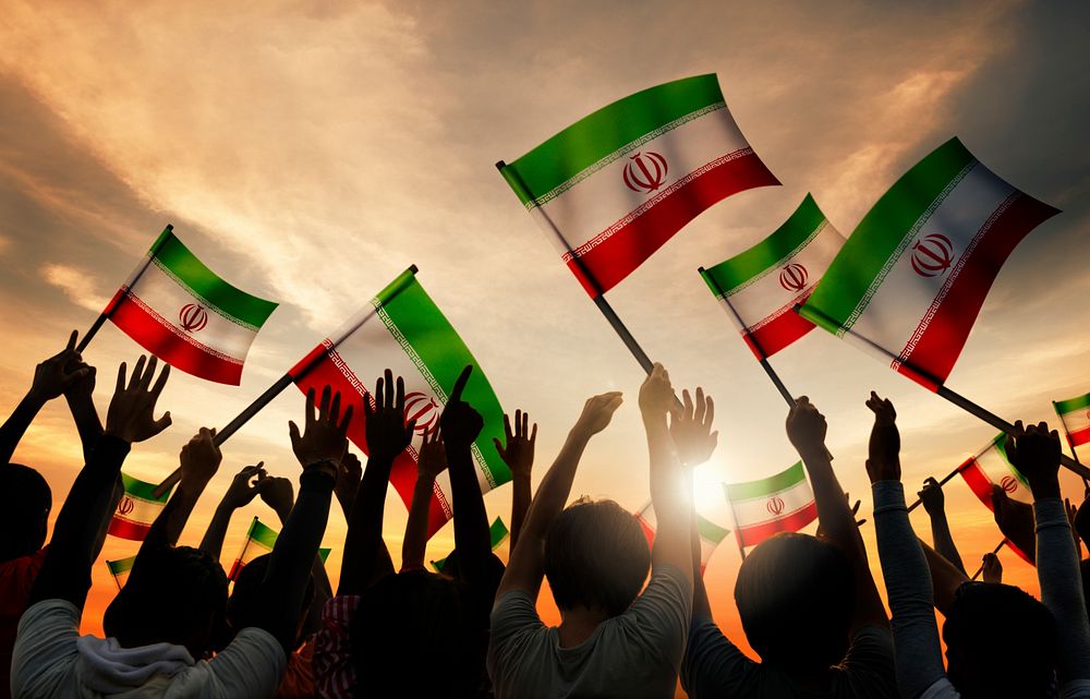 Silhouettes of People Holding the Flag of Iran