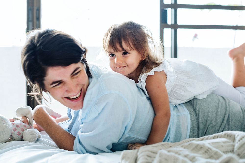 Mother and daughter playing together with happiness