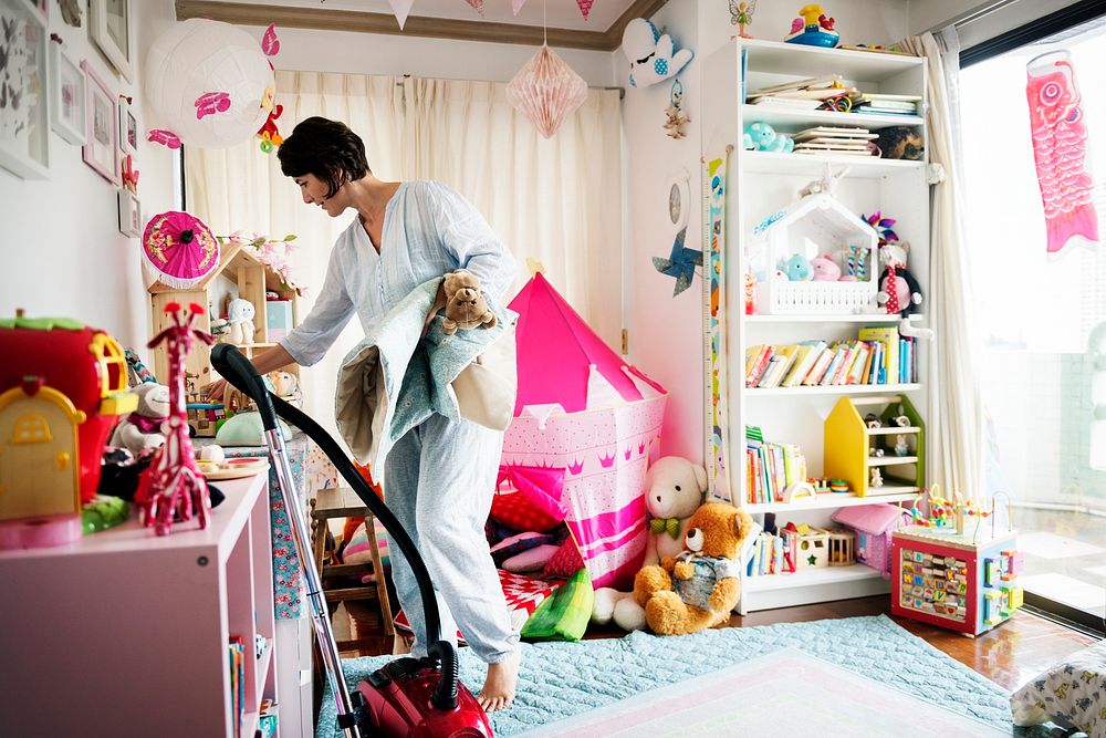 Mother cleaning daughter's room