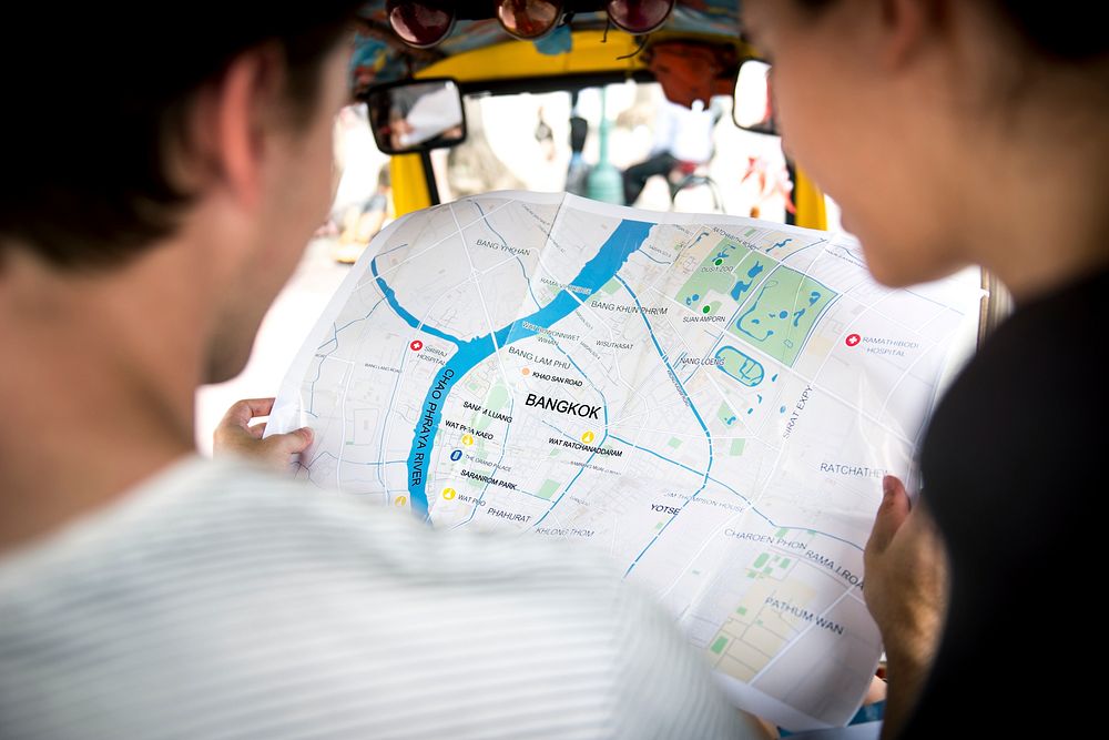 Rear view of people checking using Bangkok Thailand map