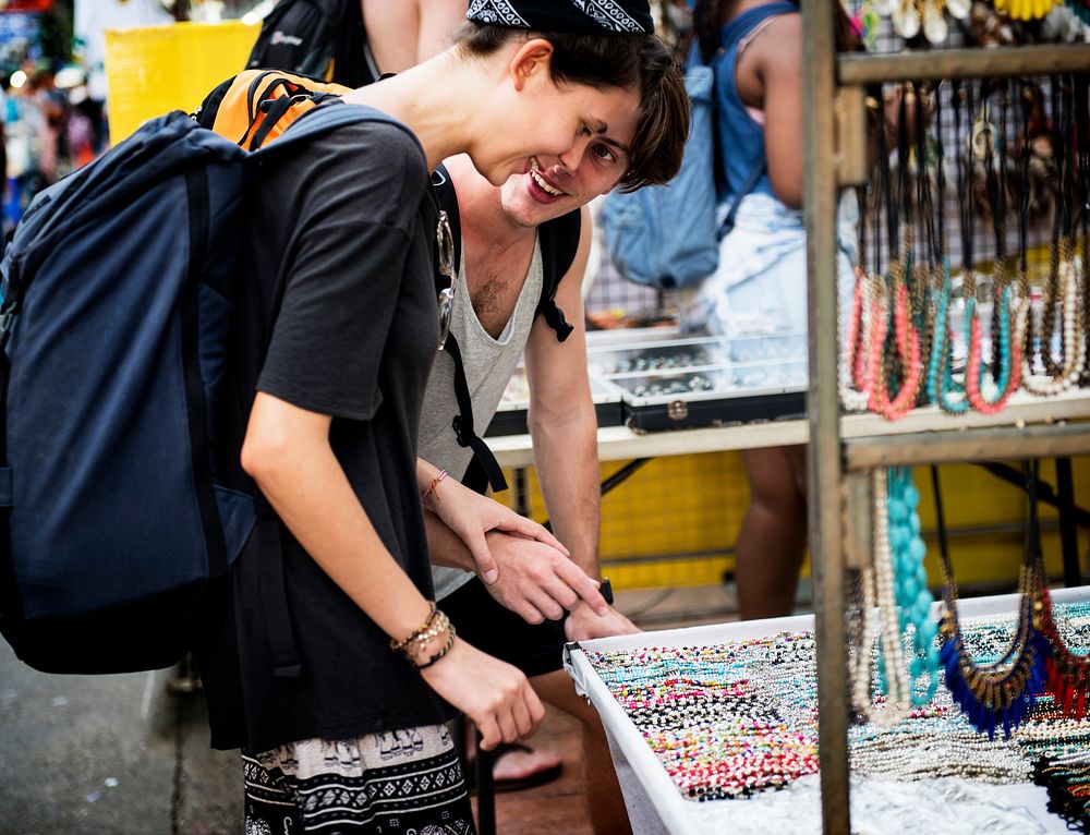 Tourist choosing handmade bracelet for souvenir