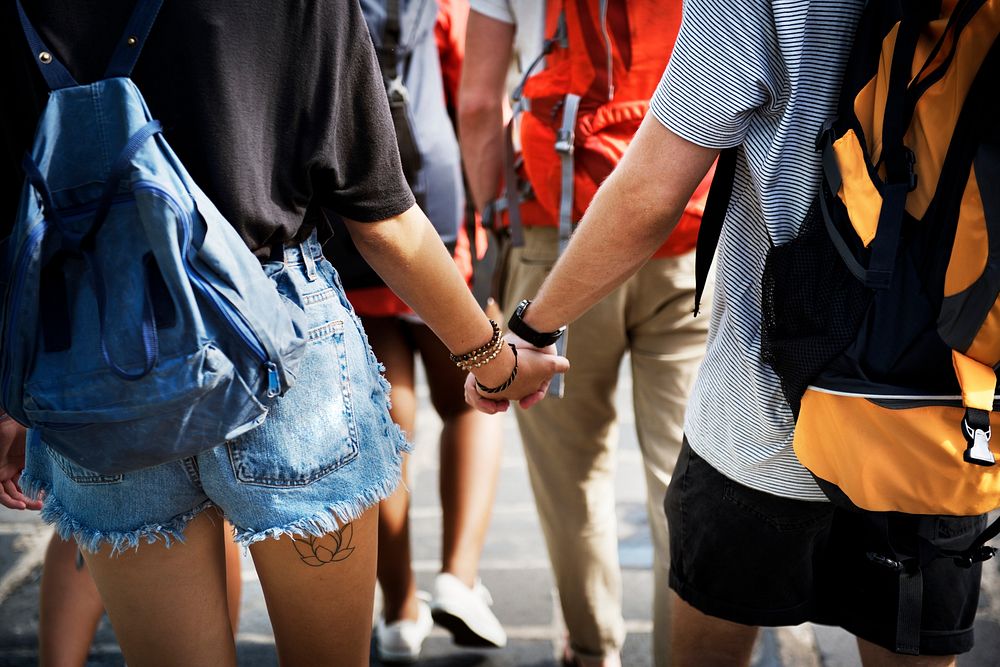 Closeup of couple holding hands while walking