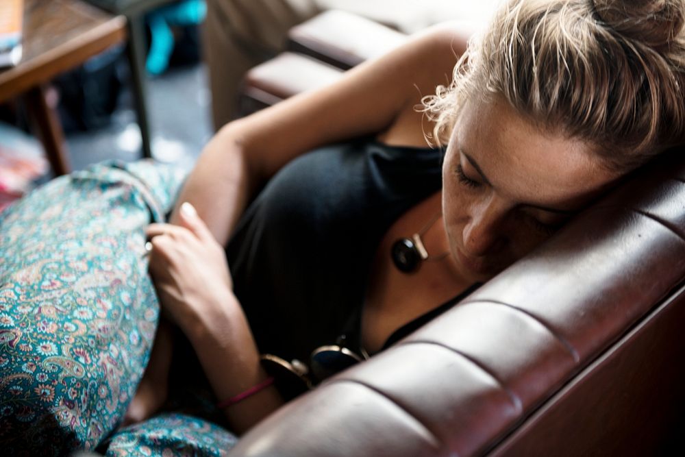 Closeup of a caucasian woman taking a nap on the couch