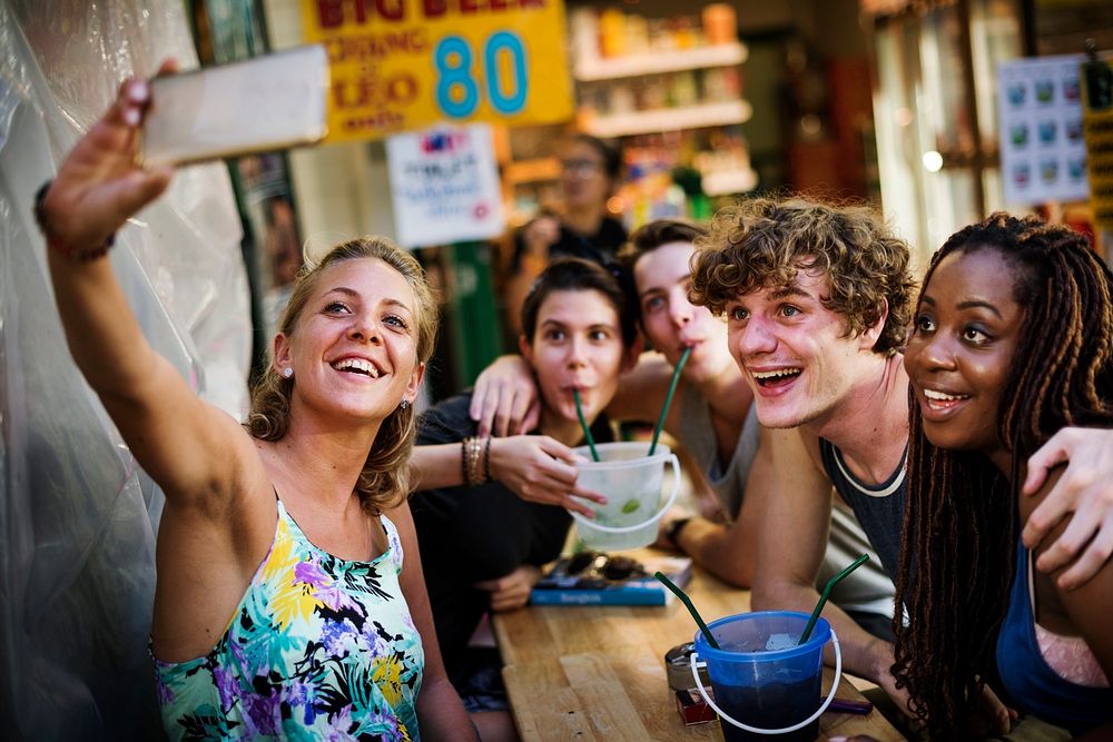 A group of tourists enjoying bucket drinks in Khao San Roa, Bangkok, Thailand