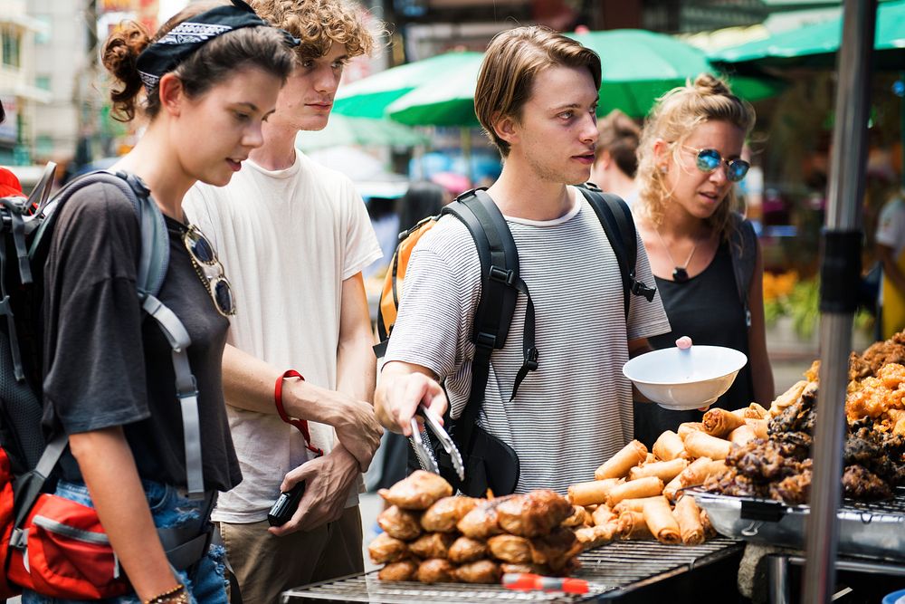 A group of tourists buying Thai Food at food stall
