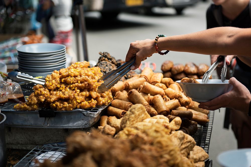 Closeup of hand ordering Thai street food