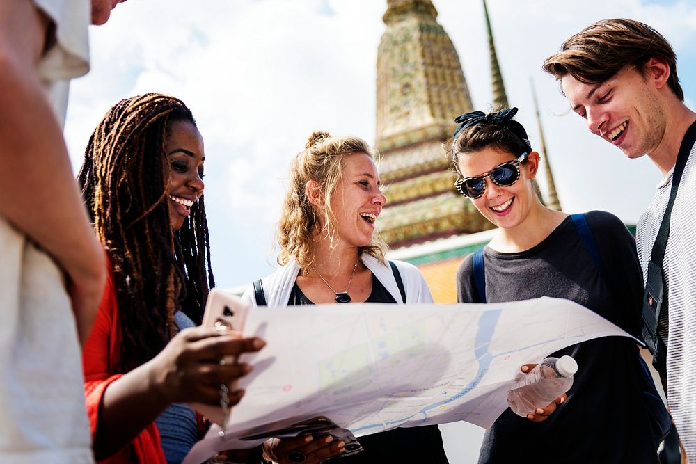 Group of tourists using the map in Thai temple