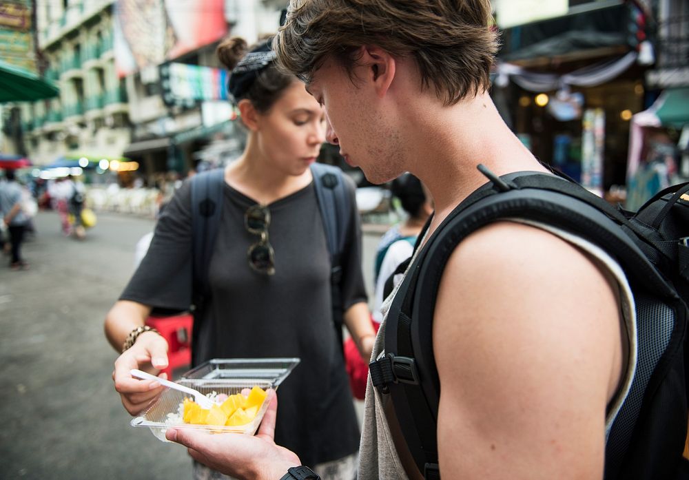 Tourists trying mango with sticky rice