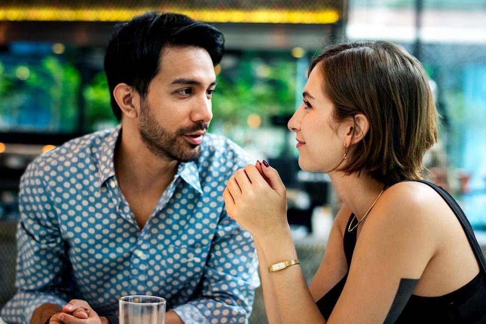 Couple in a cafe looking at each other
