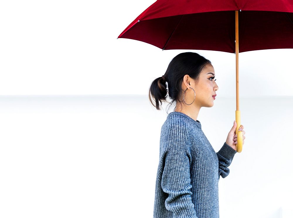 Side view of asian woman with umbrella