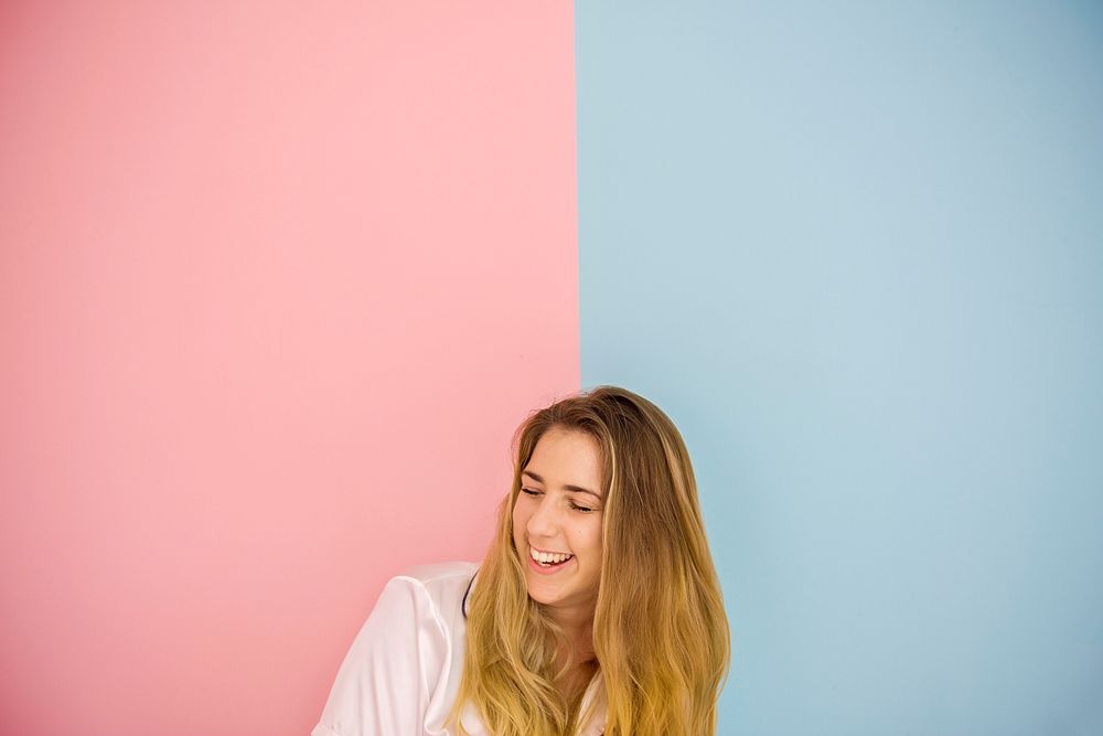 Smiling caucasian woman with pink and blue background