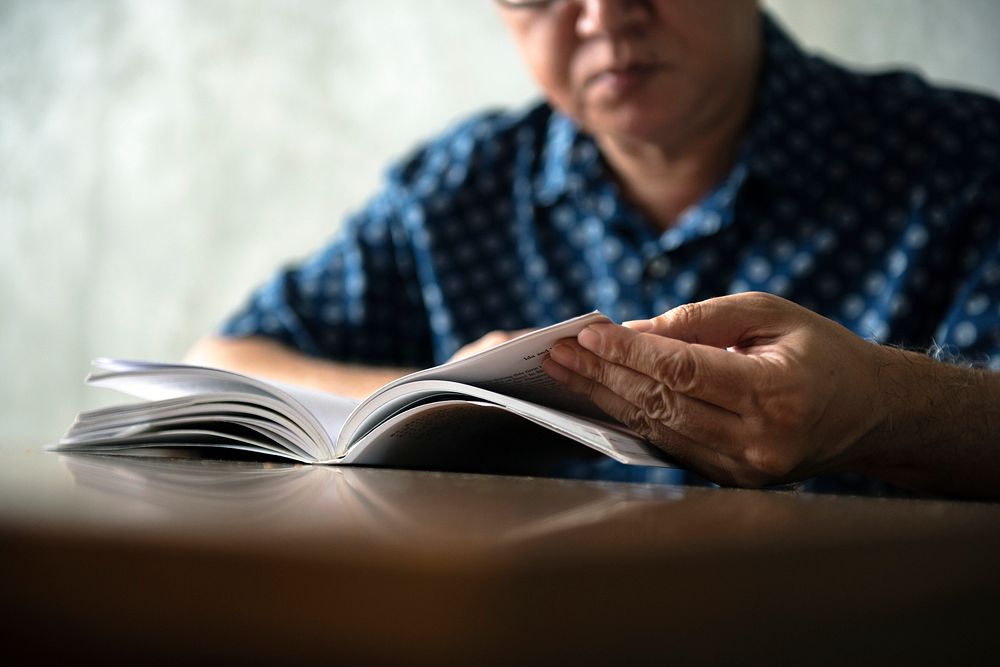 Senior man reading book at home